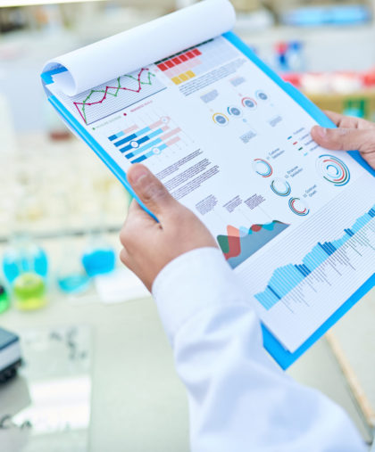 Close-up of unrecognizable laboratory worker viewing statistical data while analyzing result of DNA test